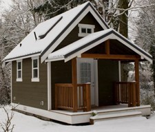 Tiny Snow-Covered Cottage with Front Porch