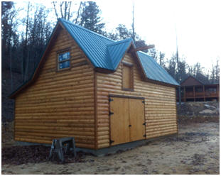 A Log-Sided Country Garage - This customized version of Don Berg's Ashokan Barn design is the garage for a log home in the woods of Alabama. Building plans are available for $35.00 at BackroadHome.net